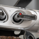 A close-up of the Ear (stick) earbuds in their charging case.